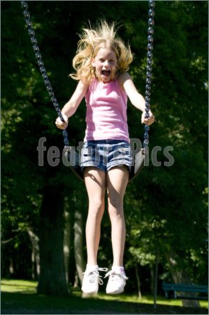 YoungGirlPlayingSwingSetPark66992.jpg